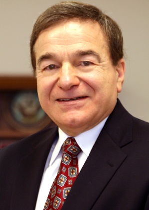 A person in a suit smiling

Description automatically generated with medium confidence