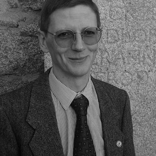 A person wearing glasses and a suit
Description automatically generated with medium confidence