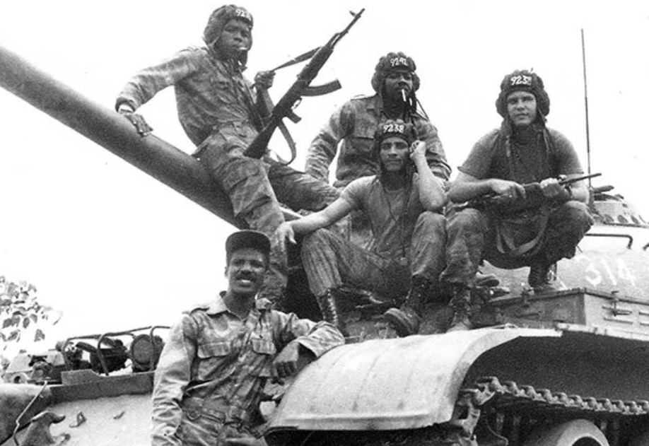 A group of people sitting on a tank

Description automatically generated with medium confidence