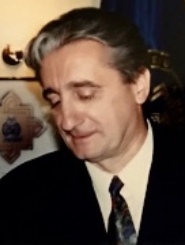 A person in a suit

Description automatically generated with medium confidence