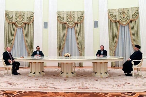 A photograph released by Russian state media shows President Vladimir V. Putin, left, and President Ebrahim Raisi of Iran at a very socially distanced meeting at the Kremlin on Wednesday.