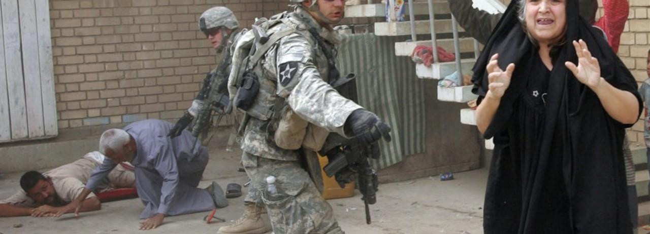U.S. troops search an Iraqi family near Baquba on October 5, 2007. (Photo: Alexander Nemenov/AFP/Getty Images) 