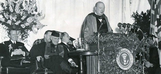 A group of men sitting at a table with microphones
Description automatically generated with medium confidence