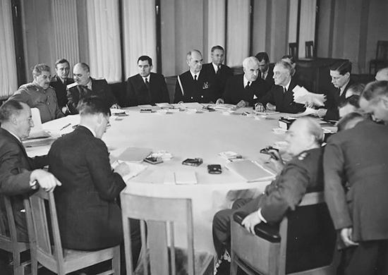 A group of people sitting around a table

Description automatically generated