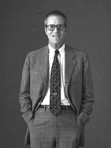 A person in a suit and tie

Description automatically generated with medium confidence