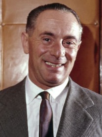 A person in a suit smiling

Description automatically generated with medium confidence