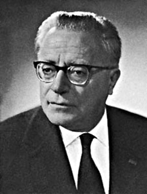 A person wearing glasses and a suit

Description automatically generated with medium confidence