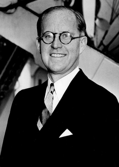 A person wearing glasses and a suit
Description automatically generated with medium confidence