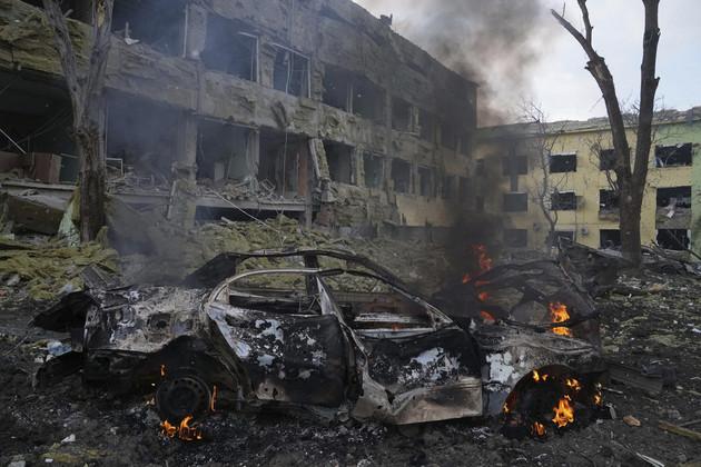 A car burns at the side of a maternity hospital that was damaged by shelling in Mariupol, Ukraine. (AP Photo/Evgeniy Maloletka, File)