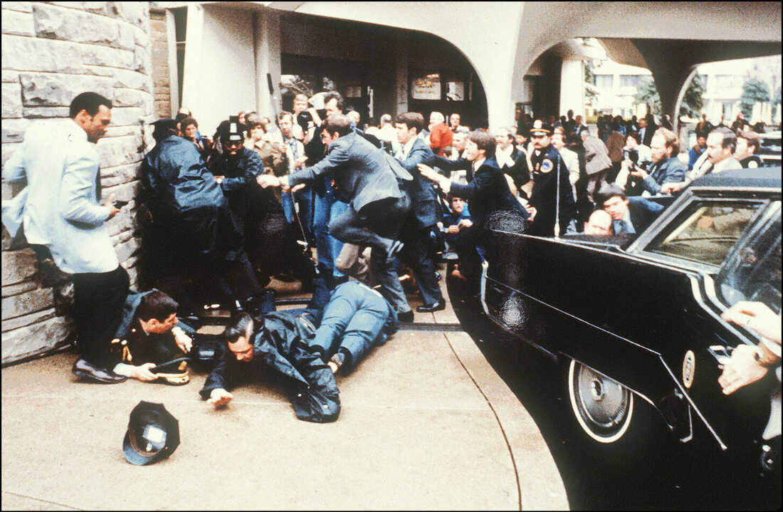 A group of people around a car
Description automatically generated with low confidence