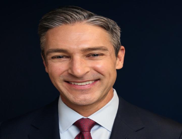 A person in a suit and tie

Description automatically generated with medium confidence