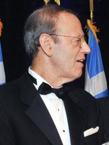 A person wearing a suit and bow tie

Description automatically generated with medium confidence