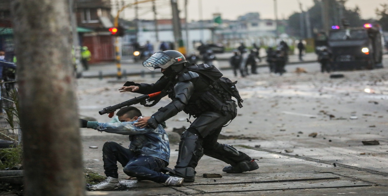 A security forces member grabs a man during a protest against the tax reform of President Ivan Duque's government in Bogota, Colombia, April 30, 2021. REUTERS/Luisa Gonzalez