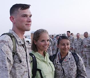 CBS Evening News anchor Katie Couric, reporting from
Iraq this week, poses with Marine Lance Cpl. James Cline,
of Asheville, N.C., left, and Sgt. Mary Alice Leone, of East
Boston, at Al-Asad Airbase in Anbar province. (AP)