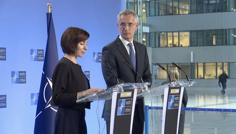 Two people standing at a podium

Description automatically generated with medium confidence