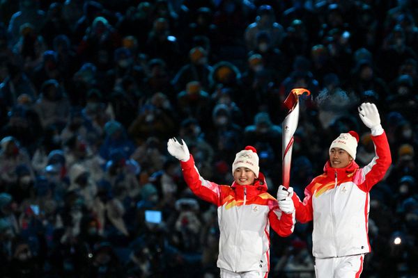 Uyghur skier who lit Olympic cauldron may end the Games as she began them –  in obscurity - The Globe and Mail