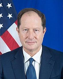 A person in a suit and tie

Description automatically generated with medium confidence