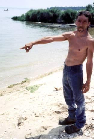 A person standing on a beach
Description automatically generated with medium confidence