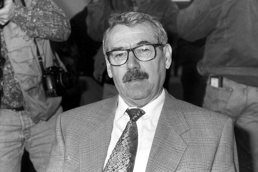 A person wearing glasses and a suit

Description automatically generated with medium confidence