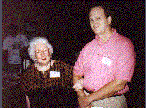 A picture containing text, person, standing, posing

Description automatically generated