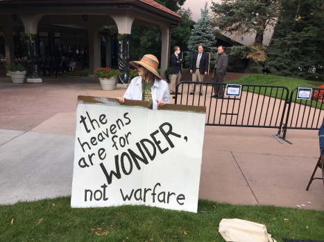 Esther Kisamoore was among a small group of protesters Monday outside The Broadmoor's International Center as the 36th Space Symposium got underway. Kisamoore, part of Citizens for Peace in Space, said just the night before she'd gazed up at the beautiful full moon in wonder. Kisamoore has protested the militarization of space at nearly every symposium held since 1984.