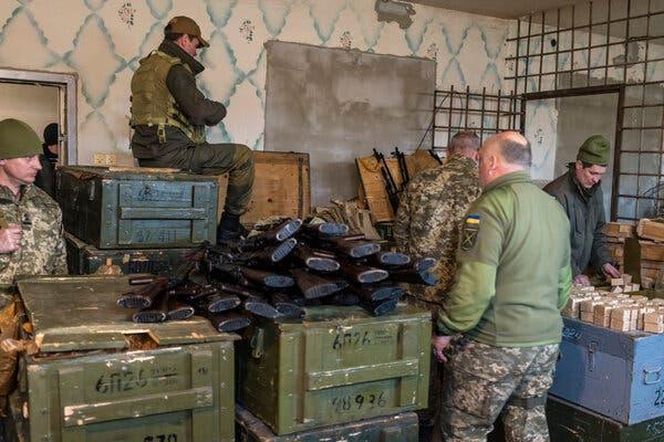 Military volunteers loading magazines with ammunition in February at a weapons storage facility in Fastiv, Ukraine.