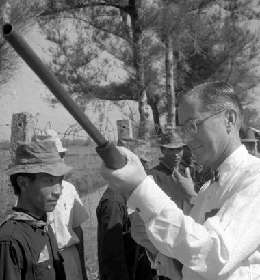 William Colby, then head of the U.S. pacification program in South Vietnam, inspects the shotgun of a rural villager in Thua Thien province in 1969. Photo by Hoorst Fass via AP Images.