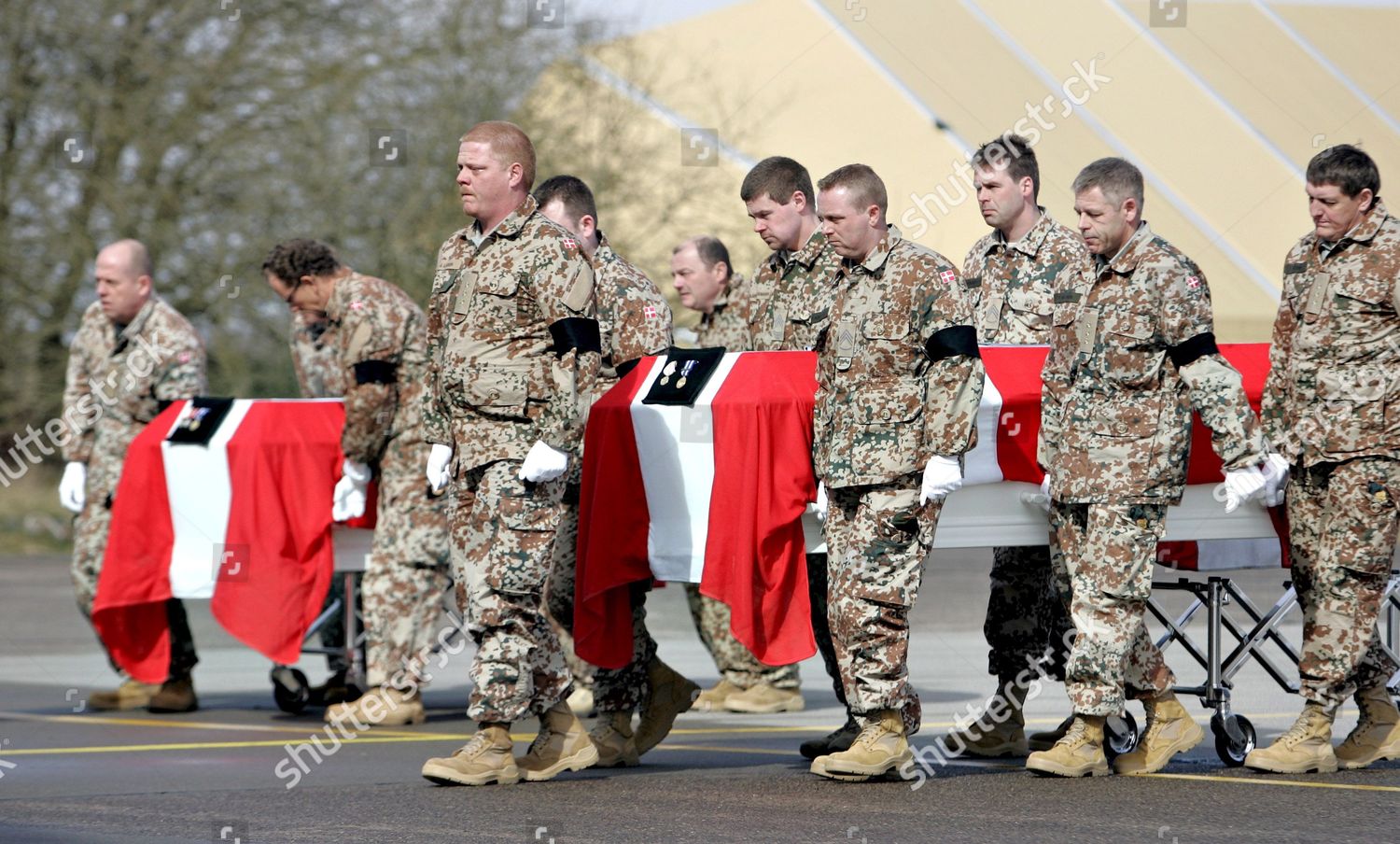 A group of soldiers carrying a flag

Description automatically generated with medium confidence