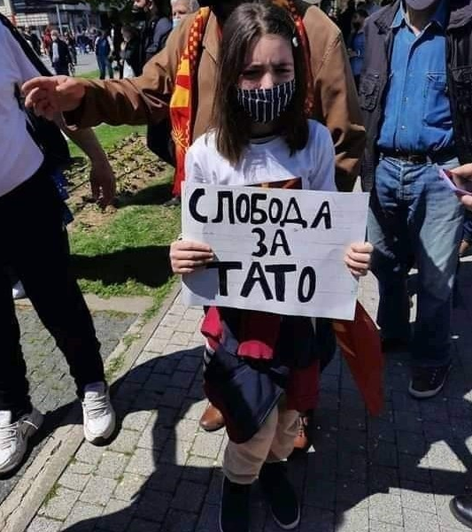 A person holding a sign

Description automatically generated with medium confidence