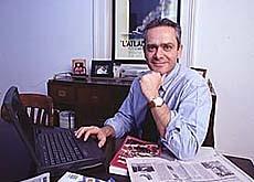 A person sitting at a desk with a computer

Description automatically generated with medium confidence