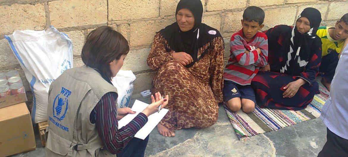 A WFP staffer interviews a Syrian family as part of needs assessment mission, which found that some 1.5 million people in Syria need food assistance over the next 3 to 6 months.