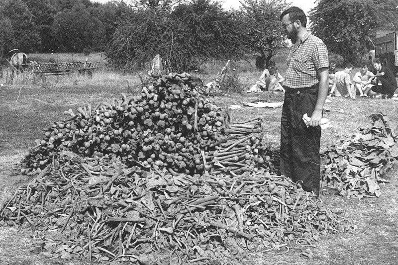 A person standing next to a pile of plants

Description automatically generated with low confidence