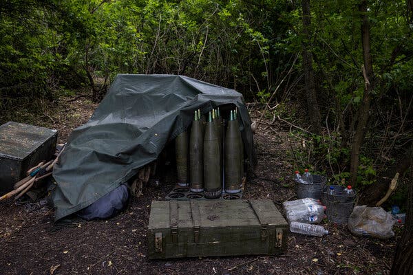 A stack of 155mm shells sat in a wooded area near a base in the Donetsk region of Ukraine.