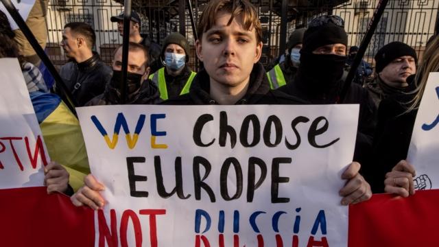 KYIV, UKRAINE - FEBRUARY 22: People hold signs and chant slogans during a protest outside the Russian Embassy on February 22, 2022 in Kyiv, Ukraine. After Russian forces concluded large-scale military exercises in Belarus amid a tense diplomatic standoff between Russia and Ukraine's Western allies, Russian President Vladimir Putin in a nation wide televised statement, recognized the independence of two breakaway regions in Eastern Ukraine and has since sent Russian "peacekeepers" to the area raising fears of a full-scale invasion. (Photo by Chris McGrath/Getty Images) *** BESTPIX ***