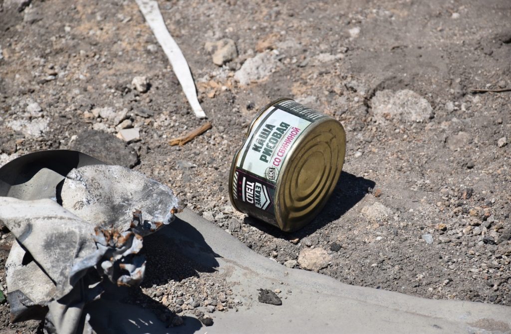 A can of beer on the ground Description automatically generated with low confidence