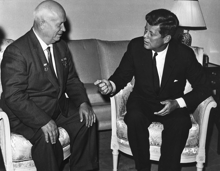 A couple of men sitting in chairs

Description automatically generated with low confidence