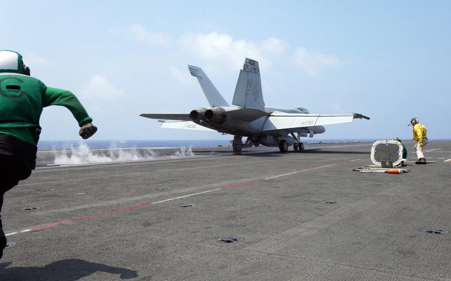 An F/A-18 Super Hornet launches from the flight deck of the aircraft carrier USS Ronald Reagan in the Philippine Sea, Friday, Aug. 5, 2022.