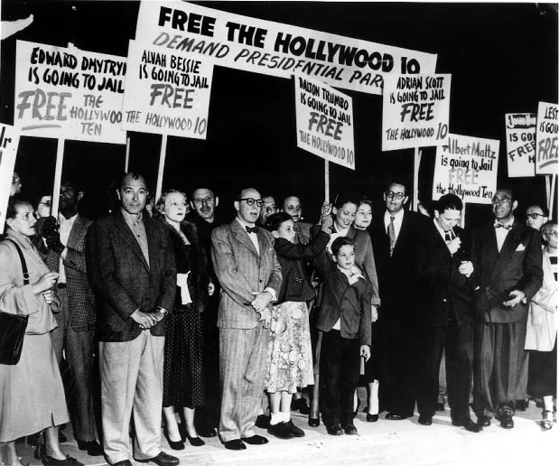 A group of people holding signs
Description automatically generated