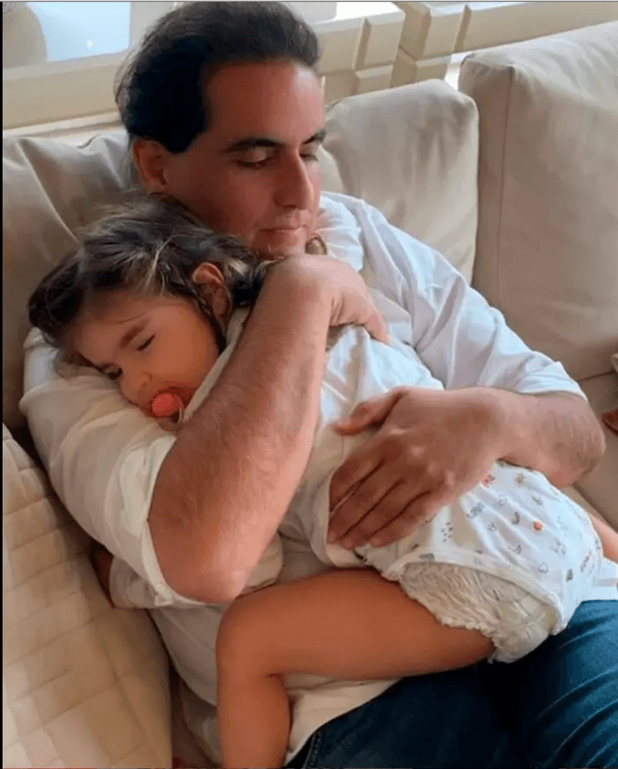 A person holding a baby

Description automatically generated