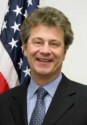 A person in a suit smiling

Description automatically generated with low confidence
