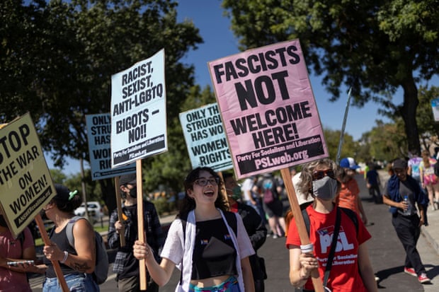 Counter-protesters hold signs that read ‘Fascists NOT welcome here!’ during a rally.