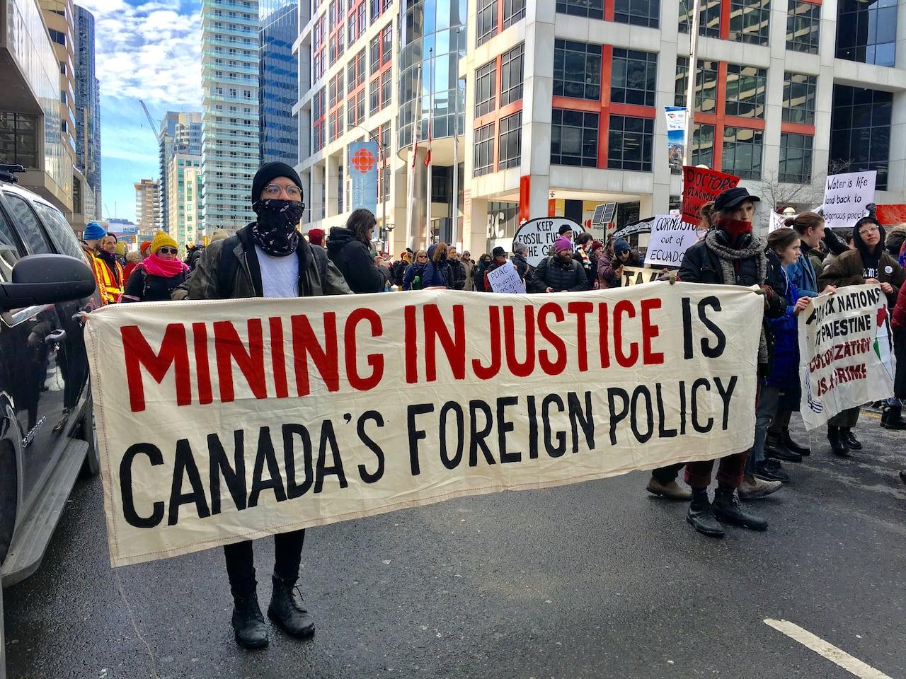 Large crowd blocks downtown street in protest against mining industry convention | CBC News