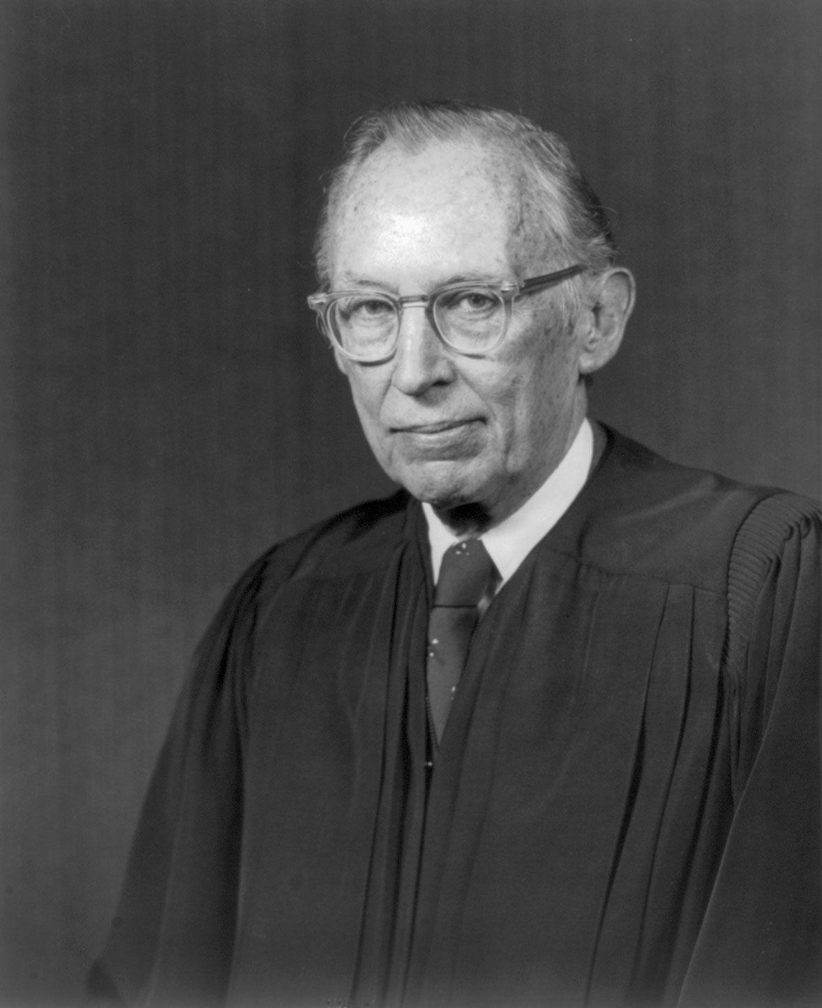A person wearing glasses and a suit

Description automatically generated with medium confidence