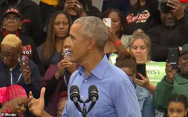 As a man tried to yell at the 44th president, he was drowned out by the partisan crowd alternately booing him, cheering and chanting Obama's name