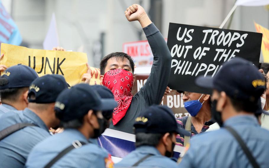A protester displays a message during a rally near the Presidential Palace to protest the three-day official visit of U.S. Vice President Kamala Harris in Manila, Philippines on Monday, Nov. 21, 2022. Harris is scheduled for talks with President Ferdinand R. Marcos Jr., Vice President Sara Duterte-Carpio as well as a visit to Palawan, an island province facing the disputed South China Sea.