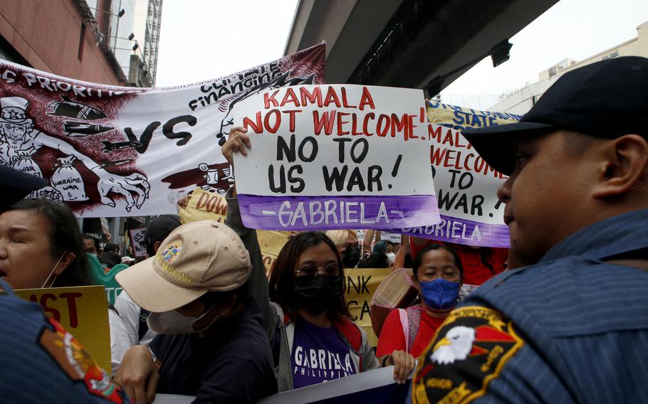 Protesters try to march closer to the Presidential Palace to protest the three-day official visit of US Vice President Kamala Harris in Manila, Philippines, Monday Nov. 21, 2022. 