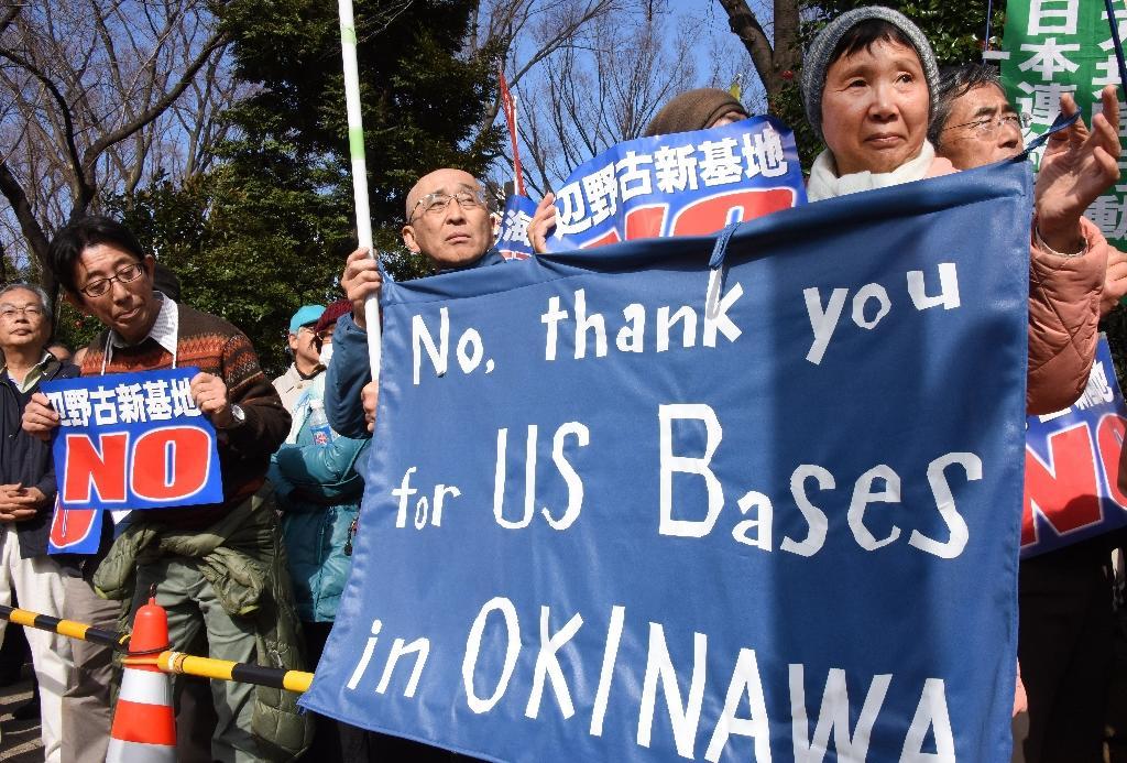 A group of people holding signs

Description automatically generated