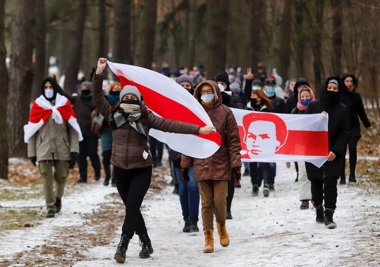 A group of people walking in the snow holding a flag

Description automatically generated with medium confidence