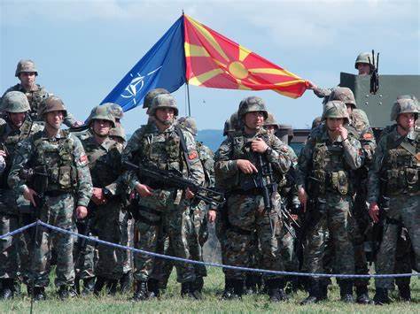 A group of soldiers holding a flag
Description automatically generated