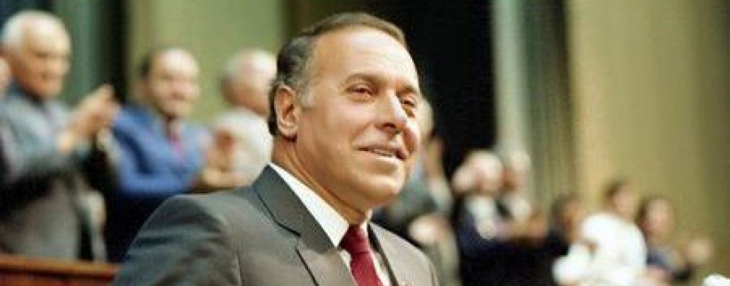 A person in a suit and tie

Description automatically generated with medium confidence
